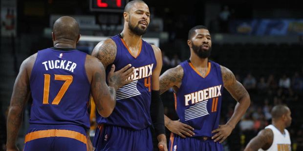 Phoenix Suns forward P.J. Tucker, left, holds back center Tyson Chandler  who argues with referees ...