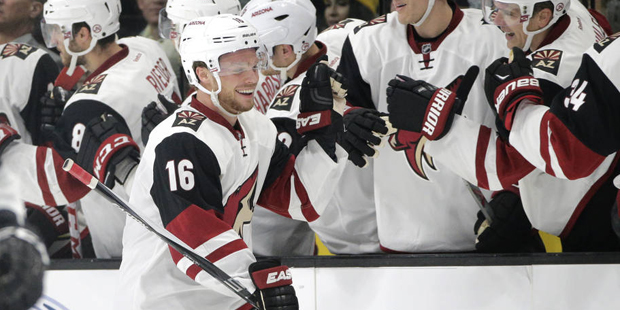 Arizona Coyotes' Max Domi, center, celebrates his goal with teammates during the second period of a...