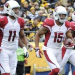 Arizona Cardinals wide receiver Michael Floyd (15) celebrates with Larry Fitzgerald after scoring a touchdown in the first quarter an NFL football game against the Pittsburgh Steelers, Sunday, Oct. 18, 2015 in Pittsburgh. (AP Photo/Don Wright)