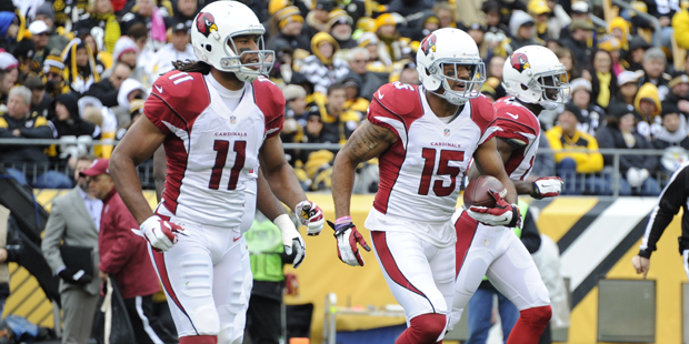 Arizona Cardinals wide receiver Michael Floyd (15) celebrates with Larry Fitzgerald after scoring a...