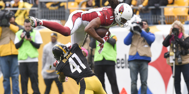 Arizona Cardinals wide receiver Larry Fitzgerald (11)runs with the ball, trying to get past Pittsbu...
