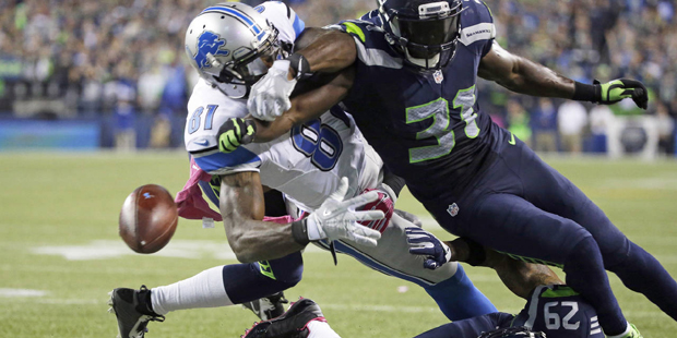 Seattle Seahawks strong safety Kam Chancellor (31) knocks the ball loose from Detroit Lions wide re...