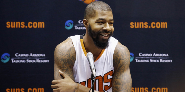 Phoenix Suns' Markieff Morris smiles as he listens to a question at a news conference during an NBA...