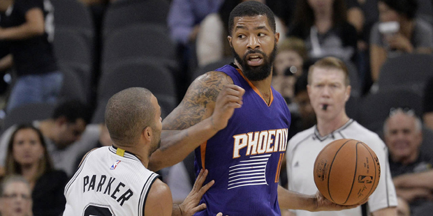 Phoenix Suns forward Markieff Morris, right, looks to pass around San Antonio Spurs guard Tony Park...