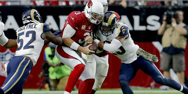 Arizona Cardinals quarterback Carson Palmer (3) is hit by St. Louis Rams free safety Rodney McLeod ...