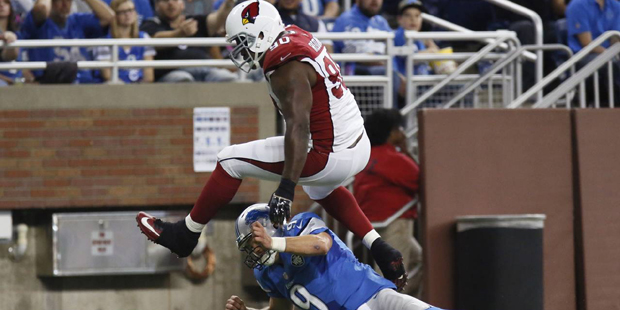 Arizona Cardinals defensive end Cory Redding (90) jumps over Detroit Lions quarterback Matthew Staf...
