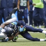 Seattle Seahawks free safety Earl Thomas (29) comes down with an interception next to Carolina Panthers' Jerricho Cotchery in the first half of an NFL football game, Sunday, Oct. 18, 2015, in Seattle. (AP Photo/Stephen Brashear)