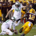 Oregon's Aidan Schneider (41) steps in to kick a field goal as Oregon's Taylor Alie (12) holds the ball while Arizona State's Tim White (12) rushes in  during the first half of an NCAA college football game Thursday, Oct. 29, 2015, in Tempe, Ariz. (AP Photo/Ross D. Franklin)