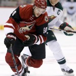 Arizona Coyotes' Antoine Vermette (50) skates in front of Minnesota Wild's Mikko Koivu, right, of Finland, to control the puck during the first period of an NHL hockey game Thursday, Oct. 15, 2015, in Glendale, Ariz. (AP Photo/Ross D. Franklin)