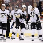 From left to right, Pittsburgh Penguins' Patric Hornqvist, of Sweden, Marc-Andre Fleury, Ben Lovejoy, and Evgeni Malkin, of Russia, skate away after a goal scored by Arizona Coyotes' Jordan Martinook during the second period of an NHL hockey game Saturday, Oct. 10, 2015, in Glendale, Ariz. (AP Photo/Ross D. Franklin)