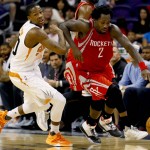 Houston Rockets' Patrick Beverley (2) pushes the ball up court as Phoenix Suns' Archie Goodwin defends during the first half of an NBA preseason basketball game, Tuesday, Oct. 13, 2015, in Phoenix. (AP Photo/Matt York)