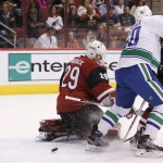 Vancouver Canucks' Brendan Gaunce (50) deflects the puck past Arizona Coyotes' Anders Lindback (29), of Sweden, for a goal during the first period of an NHL hockey game Friday, Oct. 30, 2015, in Glendale, Ariz. (AP Photo/Ross D. Franklin)