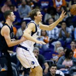 Dallas Mavericks' Dirk Nowitzki backs down Phoenix Suns' Jon Leuer during the second half of an NBA basketball game, Wednesday, Oct. 28, 2015, in Phoenix. (AP Photo/Matt York)