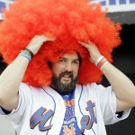 New York Mets fan John Brugger adjusts his wig before Game 4 of the Major League Baseball World Series against the Kansas City Royals Saturday, Oct. 31, 2015, in New York. (AP Photo/David J. Phillip)