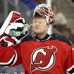 New Jersey Devils goalie Cory Schneider sprays water on his face during the first period of an NHL hockey game against the Arizona Coyotes, Tuesday, Oct. 20, 2015, in Newark, N.J. (AP Photo/Julio Cortez)