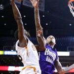 Phoenix Suns' Henry Sims, left, gets fouled by Sacramento Kings' Willie Cauley-Stein (00) as he goes up for a shot during the second half of an NBA preseason basketball game Wednesday, Oct. 7, 2015, in Phoenix. The Suns won 102-98. (AP Photo/Ross D. Franklin)