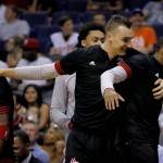 Houston Rockets players celebrate during the second half of an NBA preseason basketball game against the Phoenix Suns, Tuesday, Oct. 13, 2015, in Phoenix. (AP Photo/Matt York)
