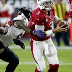 Arizona Cardinals quarterback Carson Palmer (3) is pressured by Baltimore Ravens inside linebacker C.J. Mosley (57) during the first half of an NFL football game, Monday, Oct. 26, 2015, in Glendale, Ariz. (AP Photo/Ross D. Franklin)