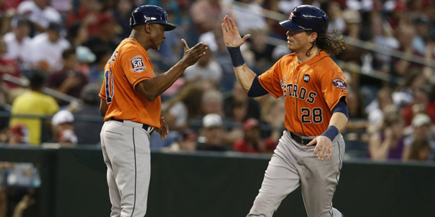 Houston Astros Colby Rasmus (28) celebrates with third base coach Gary Pettis after hitting a solo ...