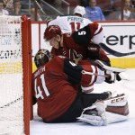 Minnesota Wild's Zach Parise (11) skates away to celebrate after scoring a goal against Arizona Coyotes' Mike Smith (41) as Coyotes' Connor Murphy (5) is unable to help defend during the first period of an NHL hockey game Thursday, Oct. 15, 2015, in Glendale, Ariz. (AP Photo/Ross D. Franklin)