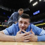 Denver Nuggets center Jusuf Nurkic, of Bosnia, makes a face at a photographer while being stretched before facing the Phoenix Suns in an NBA basketball game Friday, Oct. 16, 2015, in Denver. (AP Photo/David Zalubowski)