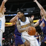 Denver Nuggets forward Wilson Chandler, front, pulls down a rebound in front of, from left, Nuggets center Nikola Jokic, of Serbia, Phoenix Suns center Alex Len, of the Ukraine, and forward Jon Leuer in the second half of an NBA basketball game Friday, Oct. 16, 2015, in Denver. The Nuggets won 106-81. (AP Photo/David Zalubowski)