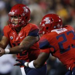 Arizona quarterback Anu Solomon, left, hands off the ball to running back Jared Baker for a long gain against Colorado in the first half of an NCAA college football game Saturday, Oct. 17, 2015, in Boulder, Colo. (AP Photo/David Zalubowski)