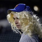 A fan wears a wig before Game 4 of the Major League Baseball World Series between the New York Mets and Kansas City Royals Saturday, Oct. 31, 2015, in New York. (AP Photo/Julie Jacobson)