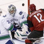 Vancouver Canucks' Richard Bachman (32) makes a save on a shot by Arizona Coyotes' Brad Richardson (12) as Canucks' Henrik Sedin (33), of Sweden, watches during the third period of an NHL hockey game Friday, Oct. 30, 2015, in Glendale, Ariz. The Canucks defeated the Coyotes 4-3. (AP Photo/Ross D. Franklin)
