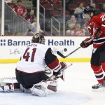 Arizona Coyotes goalie Mike Smith (41) deflects a shot by New Jersey Devils right wing Lee Stempniak (20) during the second period of an NHL hockey game, Tuesday, Oct. 20, 2015, in Newark, N.J. (AP Photo/Julio Cortez)