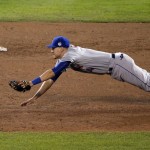New York Mets shortstop Wilmer Flores dives for a Kansas City Royals' Eric Hosmer two-RBI single during the fifth inning of Game 2 of the Major League Baseball World Series Wednesday, Oct. 28, 2015, in Kansas City, Mo. (AP Photo/Charlie Riedel)
