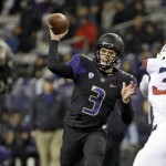Washington quarterback Jake Browning (3) throws a touchdown pass to Joshua Perkins, left, against Arizona in the first half an NCAA college football game Saturday, Oct. 31, 2015, in Seattle. (AP Photo/Elaine Thompson)