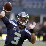 Seattle Seahawks quarterback Russell Wilson passes during warmups before an NFL football game against the Carolina Panthers, Sunday, Oct. 18, 2015, in Seattle. (AP Photo/Elaine Thompson)