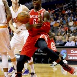 Houston Rockets' Terrence Jones (6) is fouled by Phoenix Suns' Jon Leur during the first half of an NBA preseason basketball game, Tuesday, Oct. 13, 2015, in Phoenix. (AP Photo/Matt York)