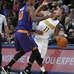 Denver Nuggets guard Erick Green, right, reacts as he is fouled by Phoenix Suns guard Sonny Weems in the second half of an NBA basketball game Friday, Oct. 16, 2015, in Denver. The Nuggets won 106-81. (AP Photo/David Zalubowski)
