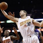 Phoenix Suns' Jon Leuer (30) grabs a rebound against the Sacramento Kings as teammate Archie Goodwin, left, looks on during the first half of an NBA preseason basketball game Wednesday, Oct. 7, 2015, in Phoenix. The Suns won 102-98. (AP Photo/Ross D. Franklin)