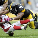 Arizona Cardinals wide receiver John Brown (12) fumbles after being hit by Pittsburgh Steelers outside linebacker James Harrison (92) in the third quarter an NFL football game Sunday, Oct. 18, 2015, in Pittsburgh. (AP Photo/Don Wright)