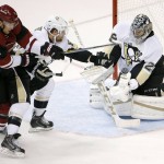 Arizona Coyotes' Martin Hanzal (11), of the Czech Republic, gets his shot deflected by Pittsburgh Penguins' Marc-Andre Fleury, right, as Penguins' Phil Kessel, center, defends during the third period of an NHL hockey game Saturday, Oct. 10, 2015, in Glendale, Ariz.  The Coyotes defeated the Penguins 2-1. (AP Photo/Ross D. Franklin)