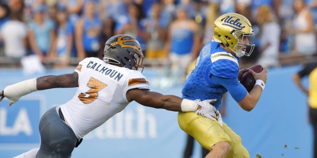 UCLA quarterback Josh Rosen, right, is sacked by Arizona State linebacker DJ Calhoun, left, during ...