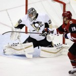 Arizona Coyotes' Shane Doan (19) reaches out for the puck after Pittsburgh Penguins' Marc-Andre Fleury (29) makes a save during the first period of an NHL hockey game Saturday, Oct. 10, 2015, in Glendale, Ariz. (AP Photo/Ross D. Franklin)