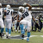 Carolina Panthers running back Jonathan Stewart (28) celebrates after scoring a touchdown against the Seattle Seahawks in the second half of an NFL football game as Panthers quarterback Cam Newton (1) looks on, Sunday, Oct. 18, 2015, in Seattle. (AP Photo/Elaine Thompson)