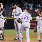 Colorado Rockies relief pitcher Justin Miller (60) is pulled from the game by manger Walt Weiss (22) during the seventh inning of a baseball game against the Arizona Diamondbacks, Thursday, Oct. 1, 2015, in Phoenix. (AP Photo/Matt York)