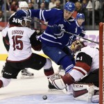 Arizona Coyotes goaltender Mike Smith, right, makes a save against Toronto Maple Leafs' Shawn Matthias, center, as Coyotes' Boyd Gordon (15) defends during second period NHL hockey action in Toronto on Monday, Oct. 26, 2015. (Frank Gunn/The Canadian Press via AP)