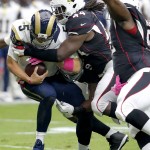 St. Louis Rams quarterback Nick Foles (5) is hit by Arizona Cardinals outside linebacker Markus Golden (44) during the first half of an NFL football game, Sunday, Oct. 4, 2015, in Glendale, Ariz. (AP Photo/Rick Scuteri)