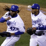 Kansas City Royals pitcher Johnny Cueto (47) and Alcides Escobar (2) celebrate the end of the top of the eighth inning of Game 2 of the Major League Baseball World Series against the New York Mets Wednesday, Oct. 28, 2015, in Kansas City, Mo. (AP Photo/David Goldman)