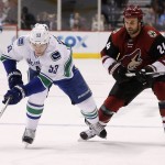 Vancouver Canucks' Bo Horvat (53) skates with the puck in front of Arizona Coyotes' Kyle Chipchura (24) during the first period of an NHL hockey game Friday, Oct. 30, 2015, in Glendale, Ariz. (AP Photo/Ross D. Franklin)