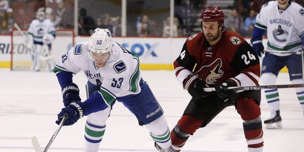 Vancouver Canucks' Bo Horvat (53) skates with the puck in front of Arizona Coyotes' Kyle Chipchura ...