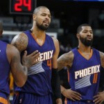 Phoenix Suns forward P.J. Tucker, left, holds back center Tyson Chandler  who argues with referees after being called for a foul while facing the Denver Nuggets in the second half of an NBA basketball game Friday, Oct. 16, 2015, in Denver. Suns forward Markieff Morris, front right, looks on. (AP Photo/David Zalubowski)