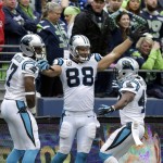Carolina Panthers tight end Greg Olsen (88) celebrates with teammates Fozzy Whittaker, right, and Devin Funchess, left, after Olsen caught a touchdown pass in the second half of an NFL football game against the Seattle Seahawks, Sunday, Oct. 18, 2015, in Seattle. The Panthers beat the Seahawks 27-23.  (AP Photo/Stephen Brashear)