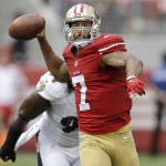 San Francisco 49ers quarterback Colin Kaepernick (7) passes in front of Baltimore Ravens outside linebacker Courtney Upshaw during the first half of an NFL football game in Santa Clara, Calif., Sunday, Oct. 18, 2015. (AP Photo/Ben Margot)